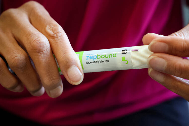 REUTERS/BRENDAN MCDERMID/FILE PHOTO
An injection pen of Zepbound, Eli Lillys weight loss drug, is displayed in New York City, in December 2023. The Food and Drug Administration today approved Eli Lillys weight-loss treatment, Zepbound, for obstructive sleep apnea, making it the first drug greenlighted to directly treat patients with the common sleeping disorder.